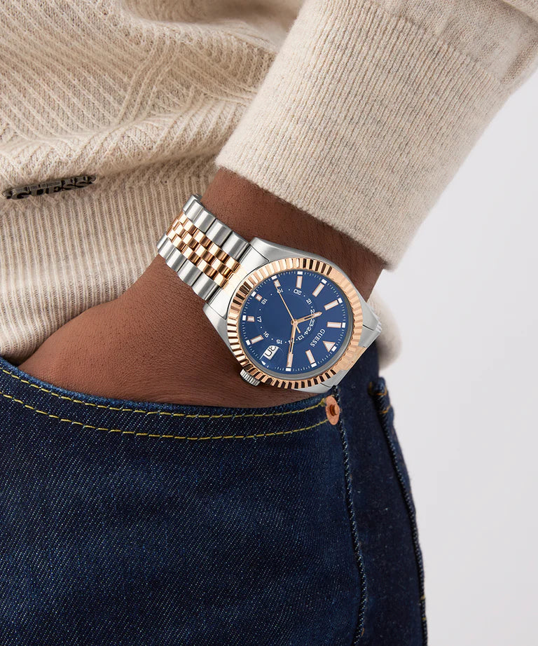 GUESS Jaden watch on wrist showing two-tone bracelet and blue dial