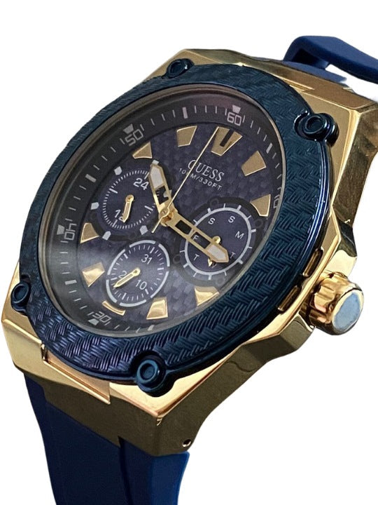 Angled view of Guess Legacy watch showing blue dial with gold hands and chronograph subdials
