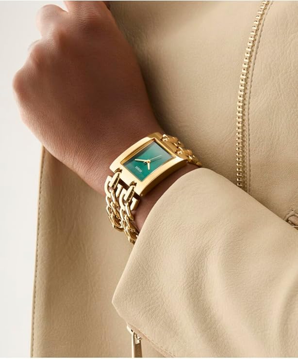GUESS MOD HEAVY METAL gold-tone watch on wrist with green dial and chain link band