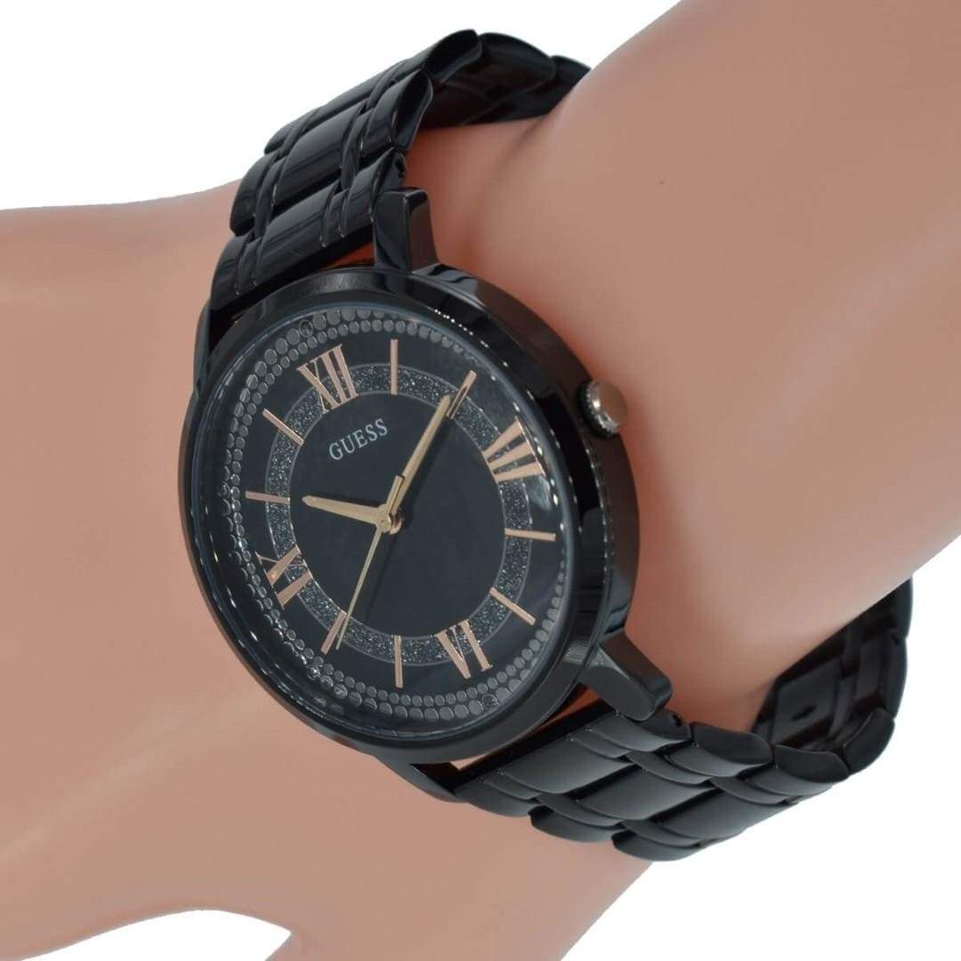 Guess Montauk watch worn on wrist showing black dial with Roman numerals