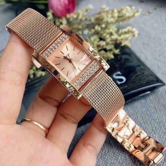 Guess Nouveau rose gold diamond watch worn on wrist with mesh bracelet