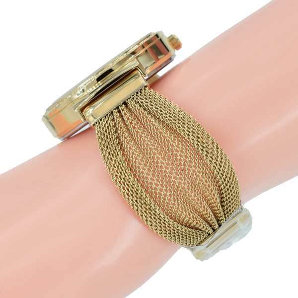Guess Originals W1083L2 gold-tone watch worn on wrist with mesh strap