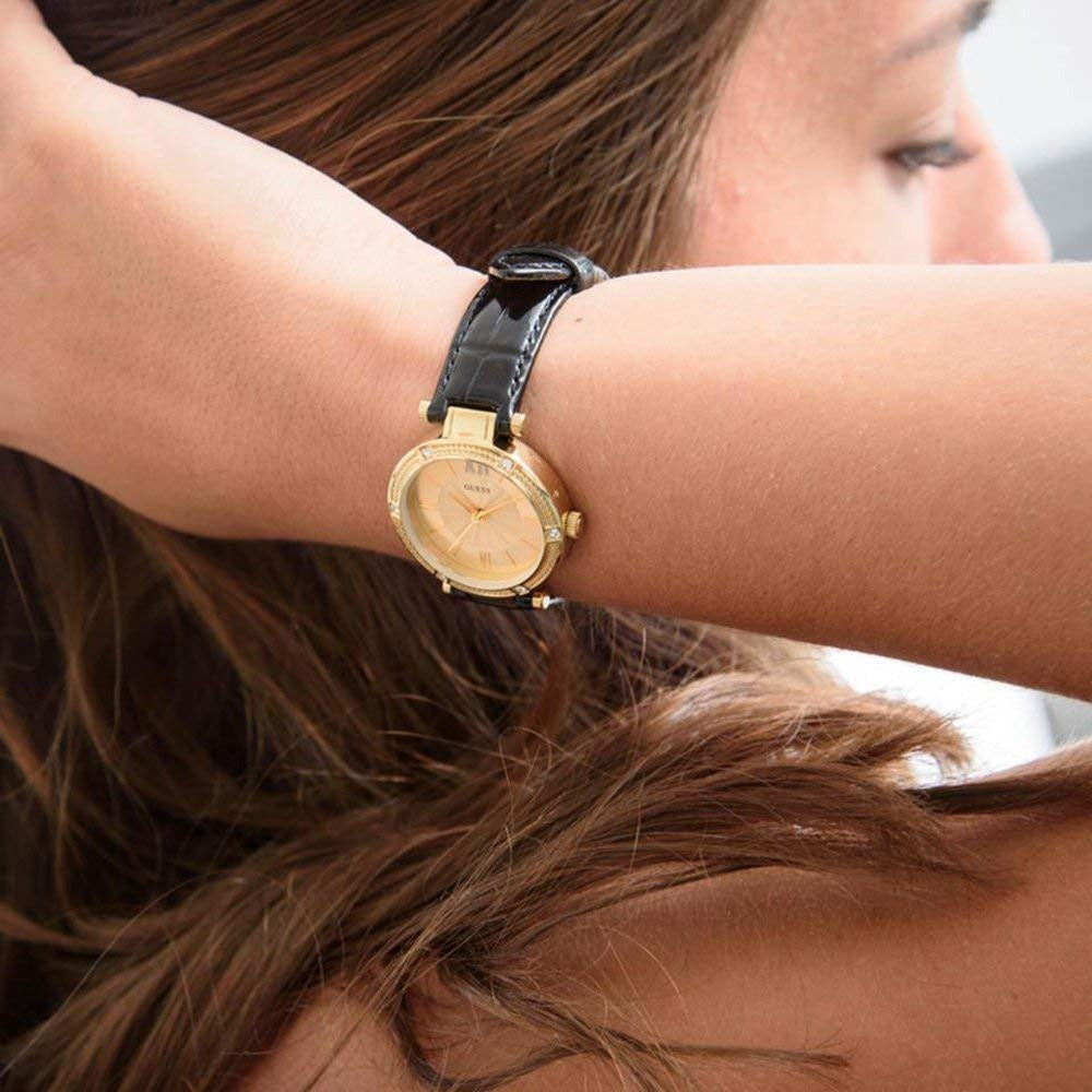 Guess Park Ave South watch on wrist with black leather strap and gold-tone case