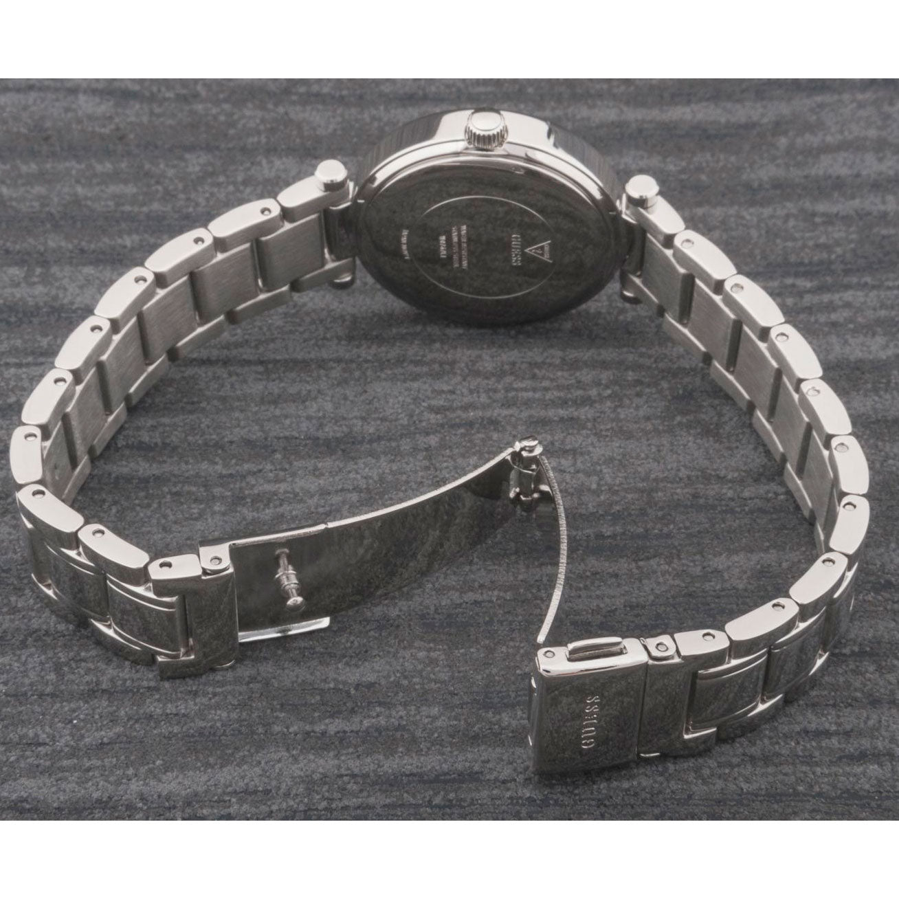 Guess Park Ave watch caseback showing engraved Guess logo and stainless steel case