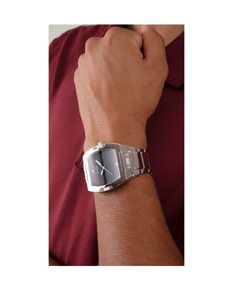Guess Phoenix men's watch worn on wrist with black dial and silver steel bracelet