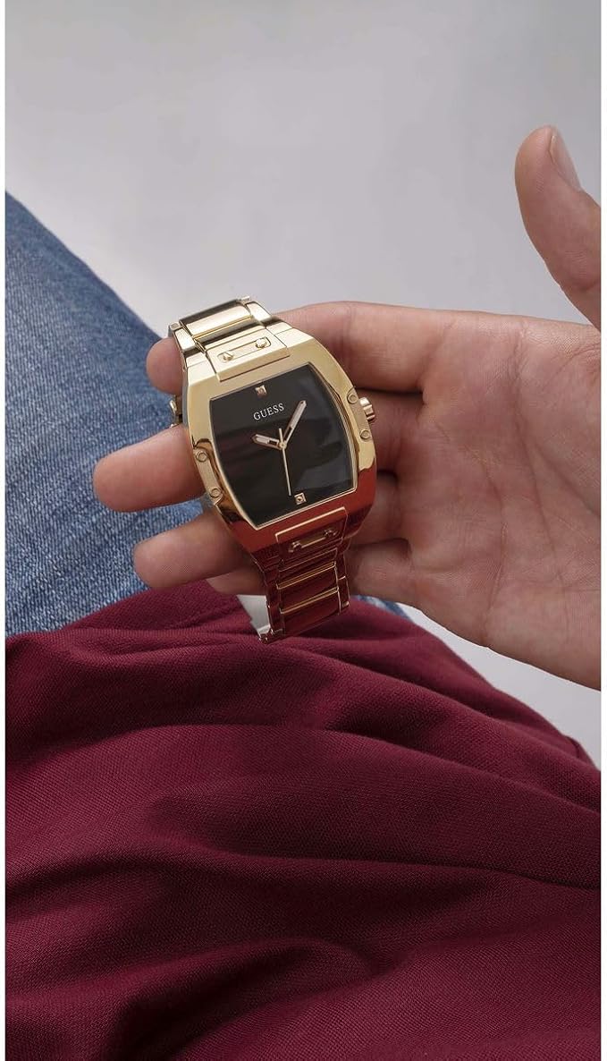 Guess Phoenix gold watch worn on wrist with black dial visible