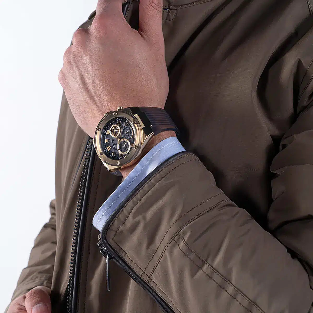 Guess Poseidon chronograph watch worn on wrist showing gold case, black dial with subdials
