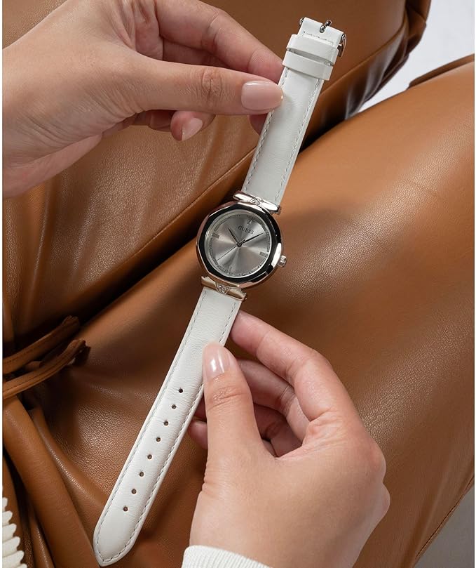 Guess Rumour watch held in hands showing silver-tone case and white leather band