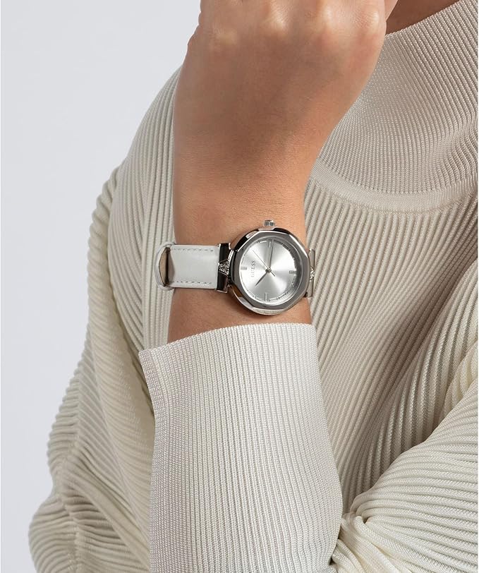 Guess Rumour watch worn on wrist with silver-tone case and white leather band