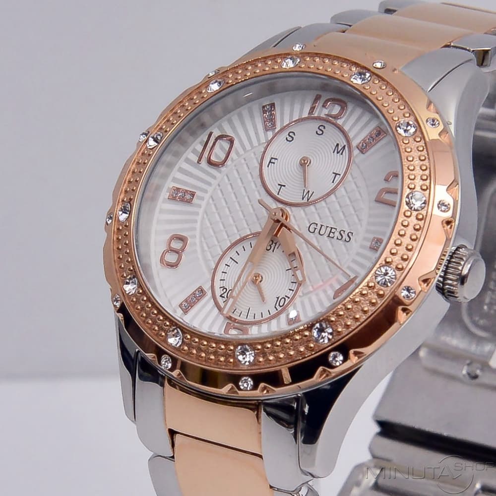 Close-up of Guess Siren dial with dual subdials, rose gold indices, and crystal bezel
