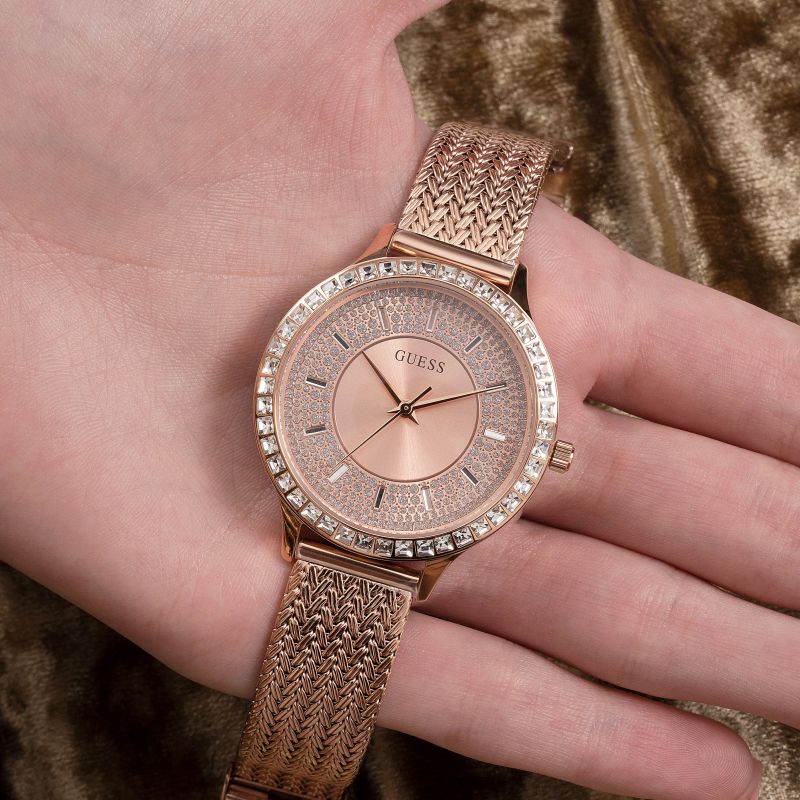 Guess Soiree rose gold mesh strap watch worn on wrist showing dial and bezel