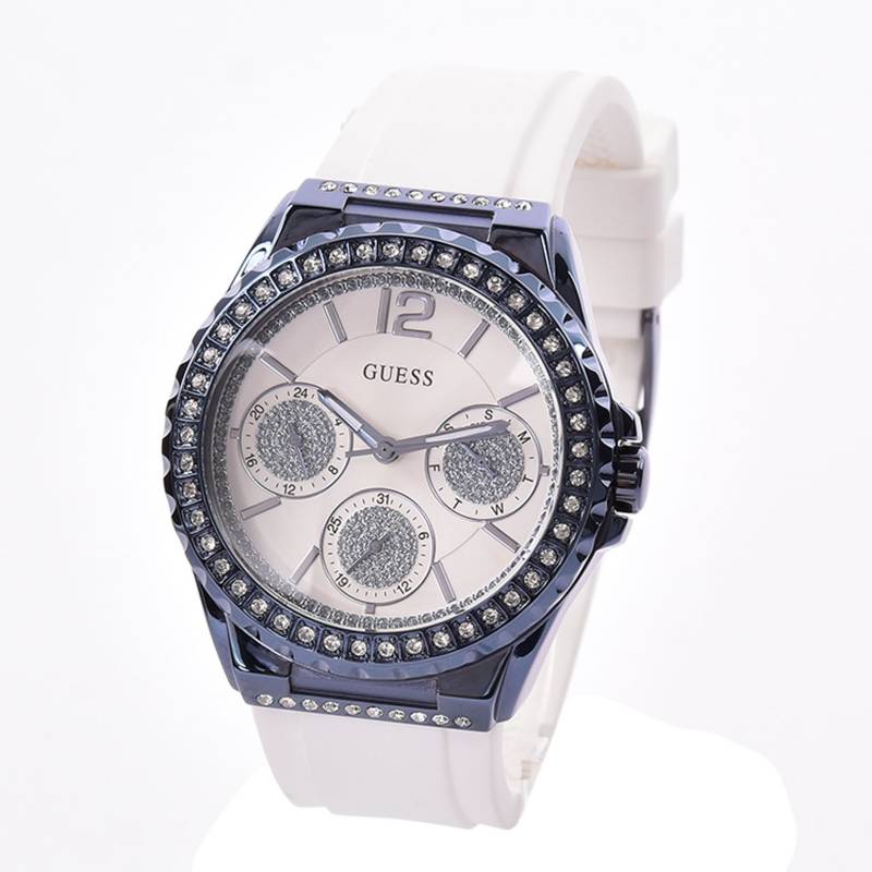 Guess Starlight watch at angle showing case, dial with three subdials, and white band
