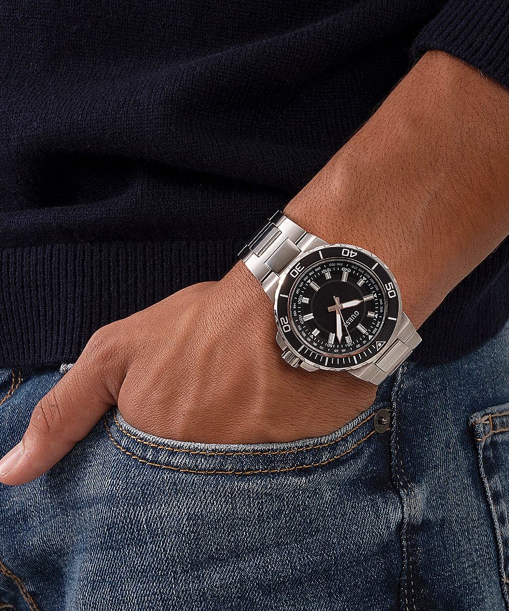 Guess Track silver tone watch worn on wrist with black dial visible