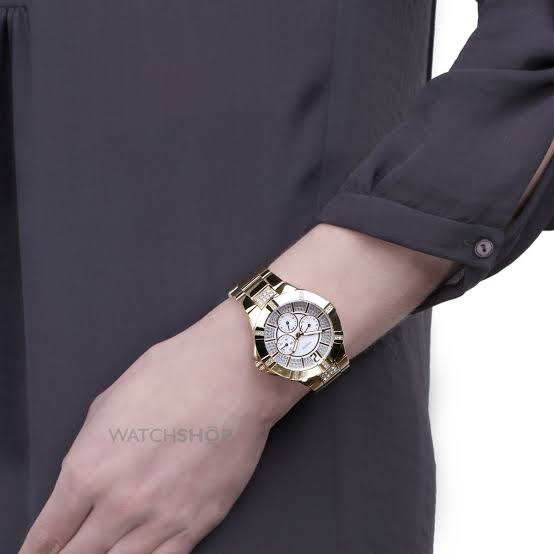 Guess Vista diamond watch worn on wrist with champagne dial and gold case