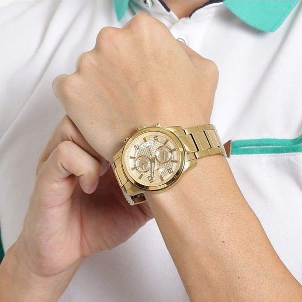 Guess W0075G5 gold chronograph watch worn on wrist
