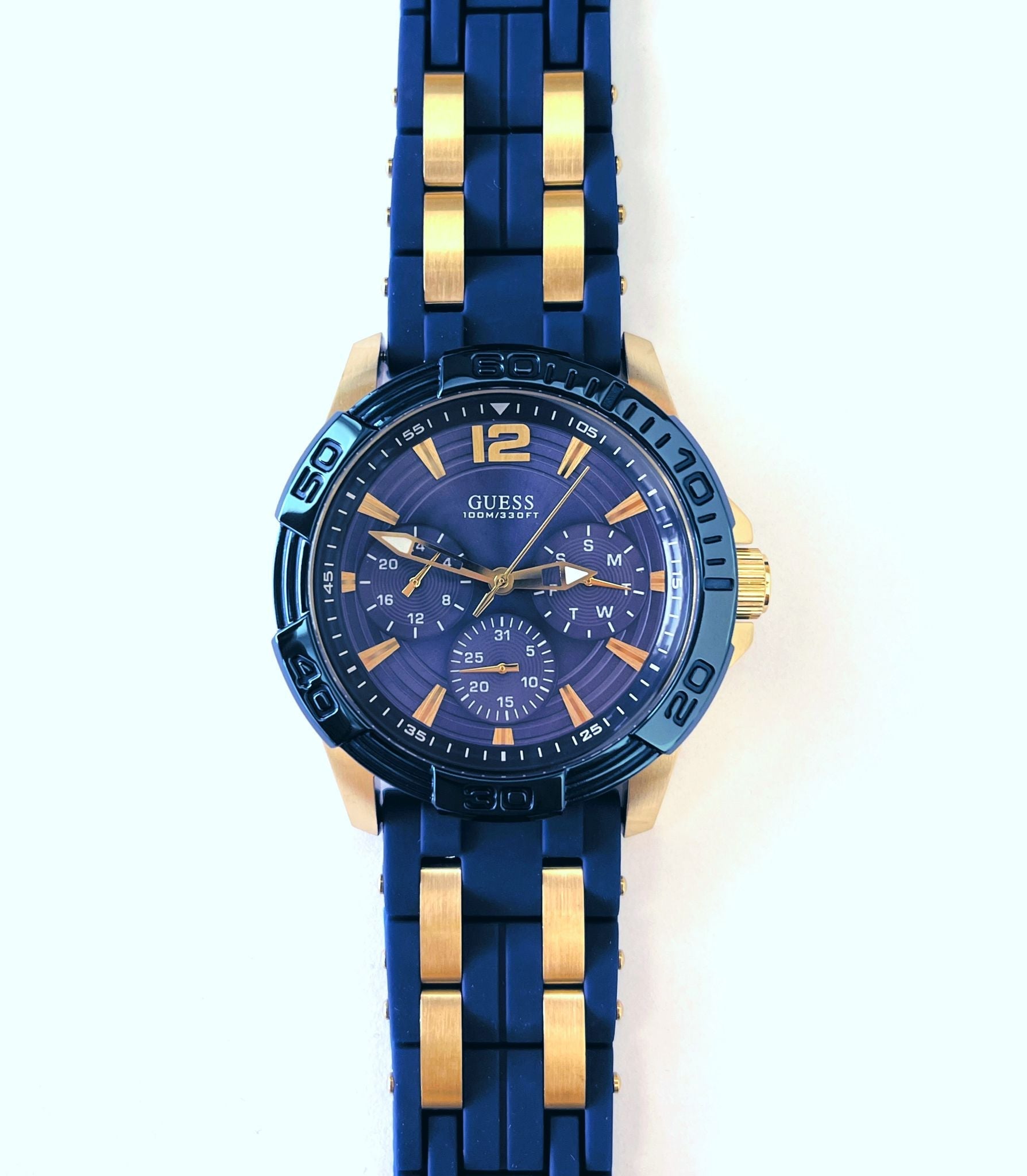Guess W0366G6 watch displayed on wrist showing full blue and gold silicon strap with contrasting panels