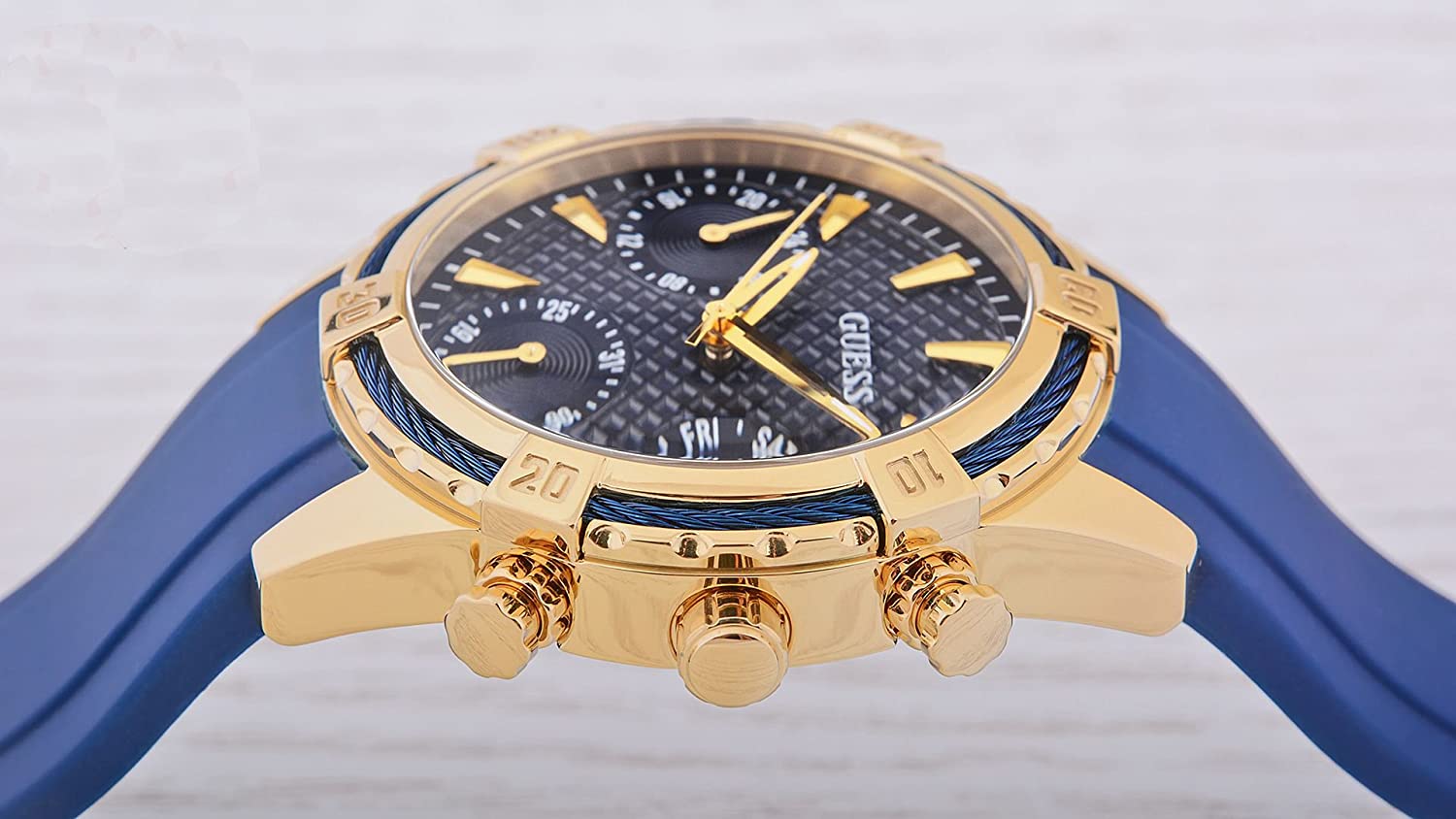 Close-up dial detail of Guess W0562L2 chronograph with blue face and gold accents