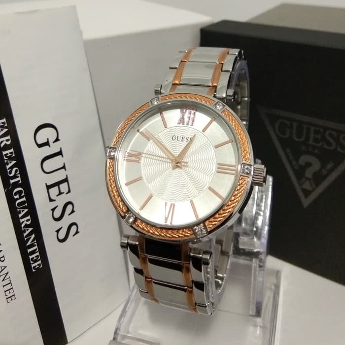 Guess diamond two-tone ladies watch displayed with Guess packaging and materials