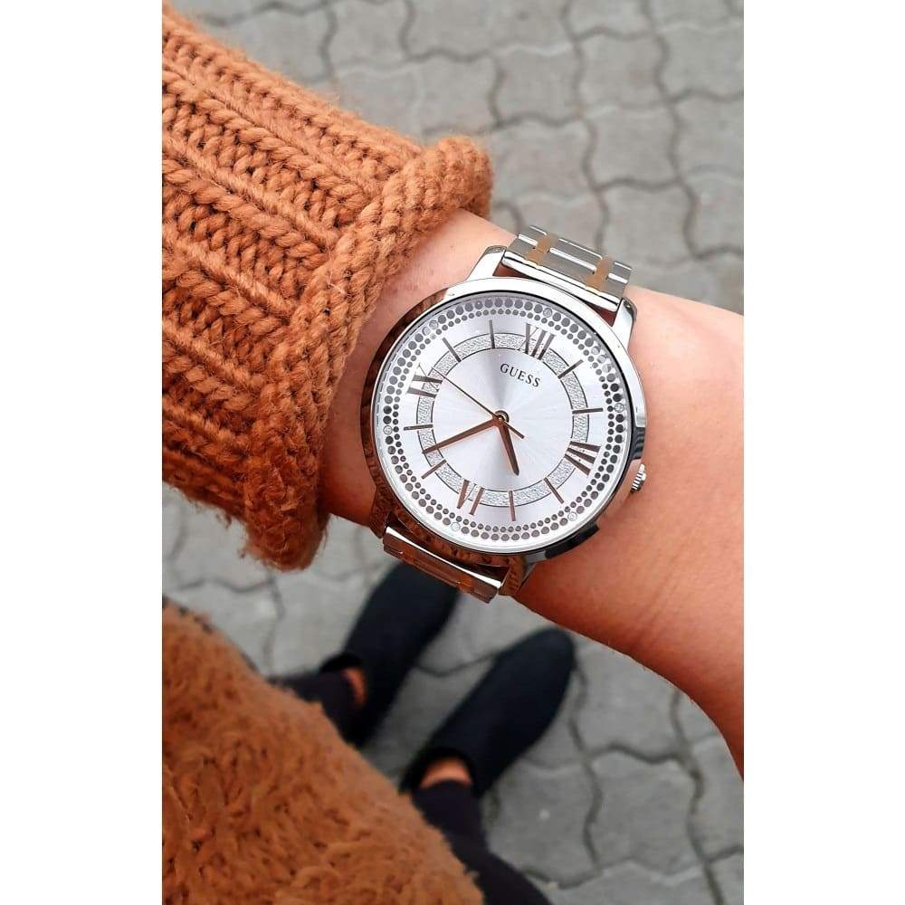 Guess W0933L6 watch worn on wrist showing silver dial and two-tone bracelet