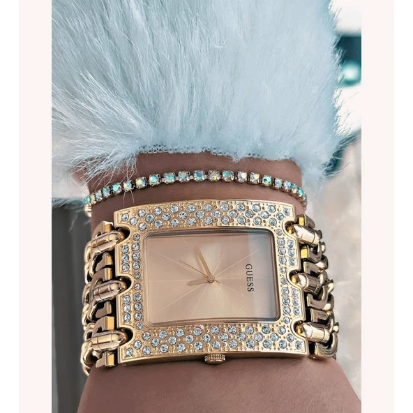 Guess Heavy Metal rose gold watch worn on wrist showing rectangular crystal-set dial and chain links