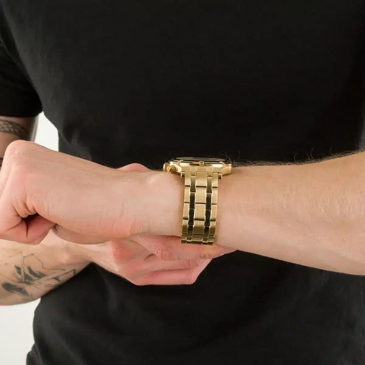Guess Continental chronograph watch on wrist showing gold case, bracelet, and champagne multi-function dial