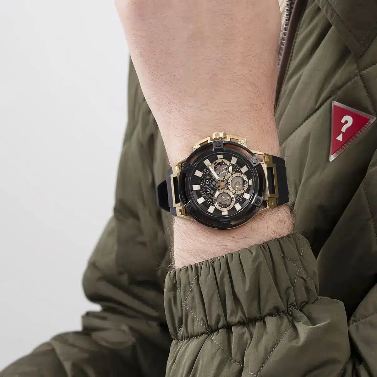 Guess Matrix watch worn on wrist showing gold case and black dial with chronograph