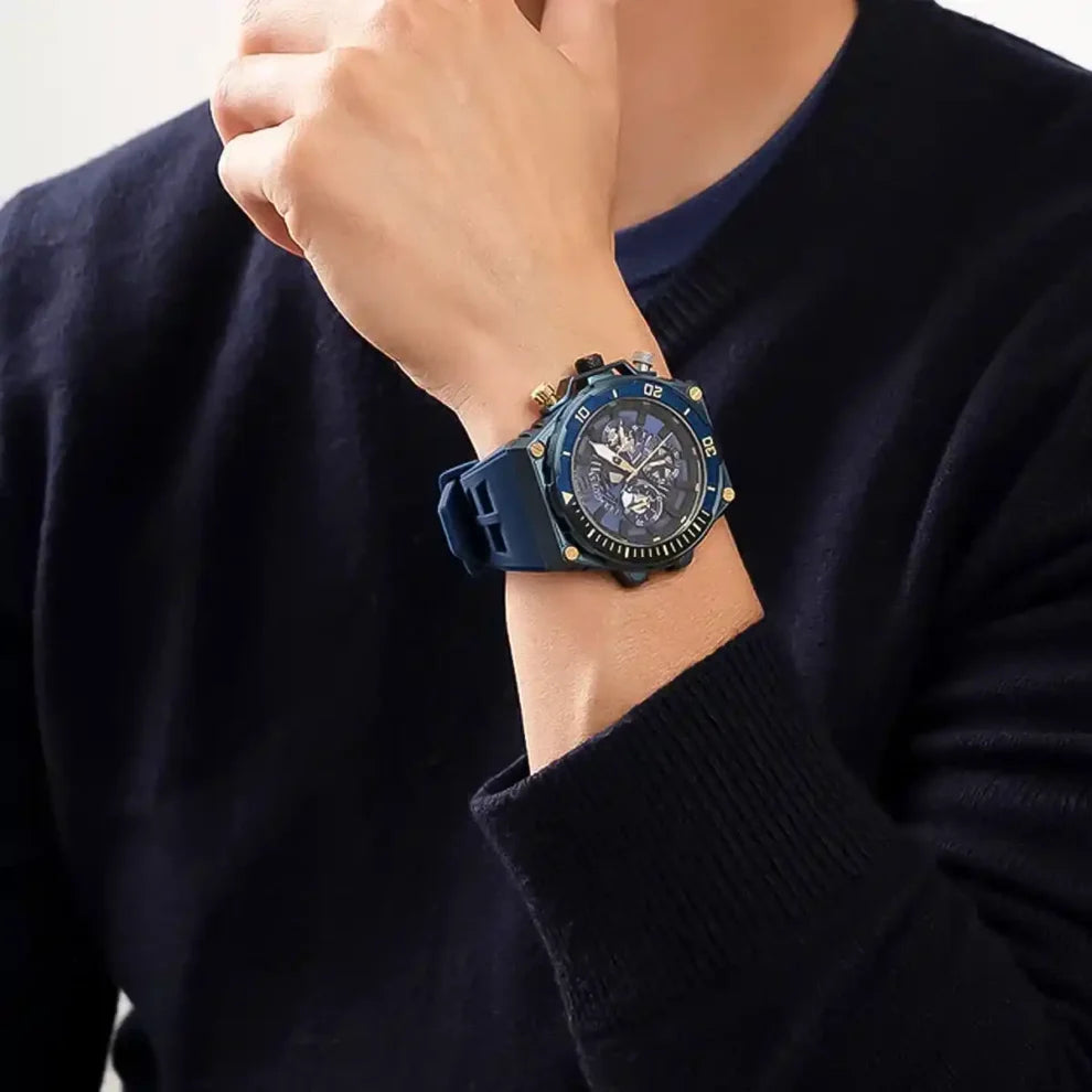 GUESS GW0443G1 blue multifunction watch worn on wrist with exposed skeleton dial