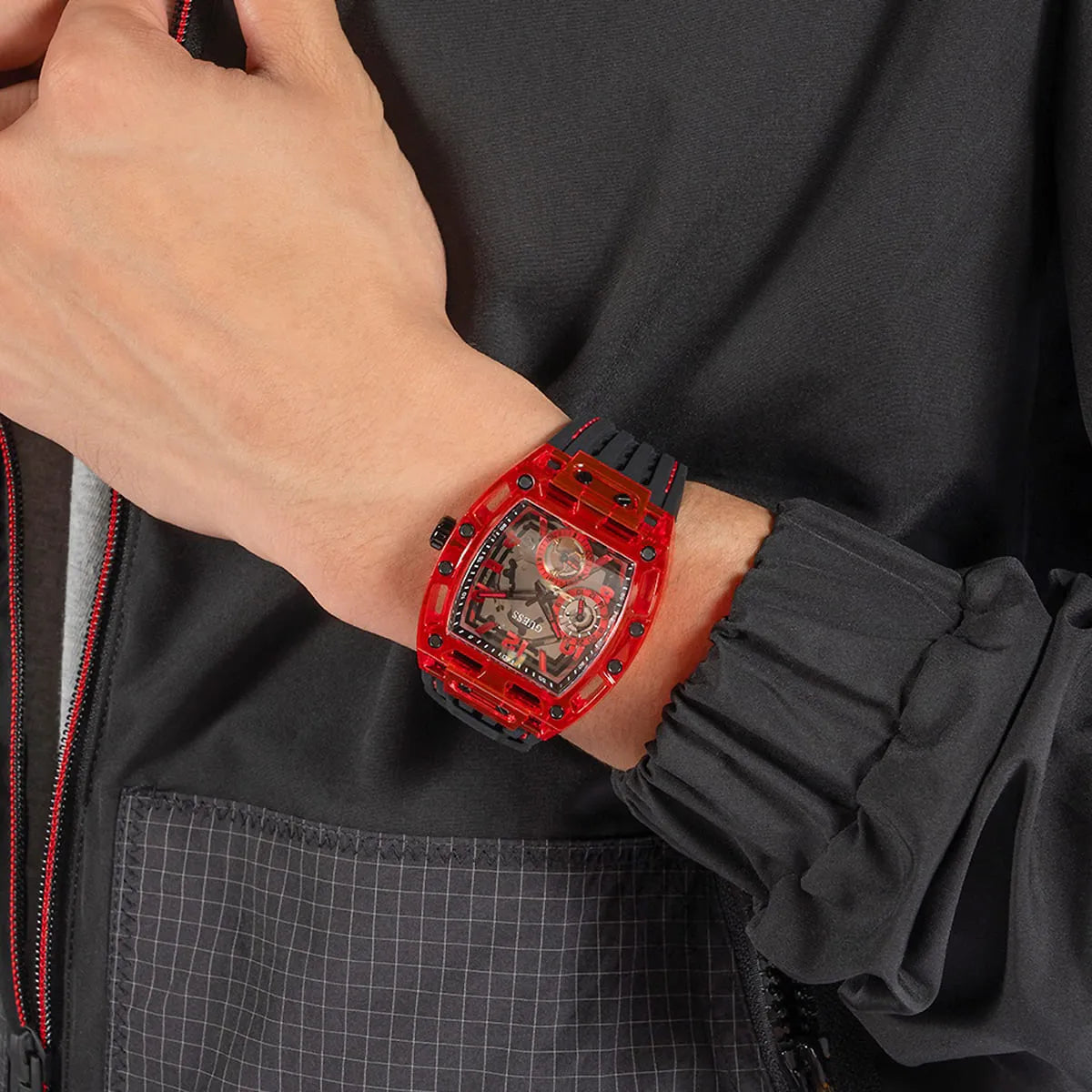 GUESS GW0499G4 red watch worn on wrist with black rubber strap