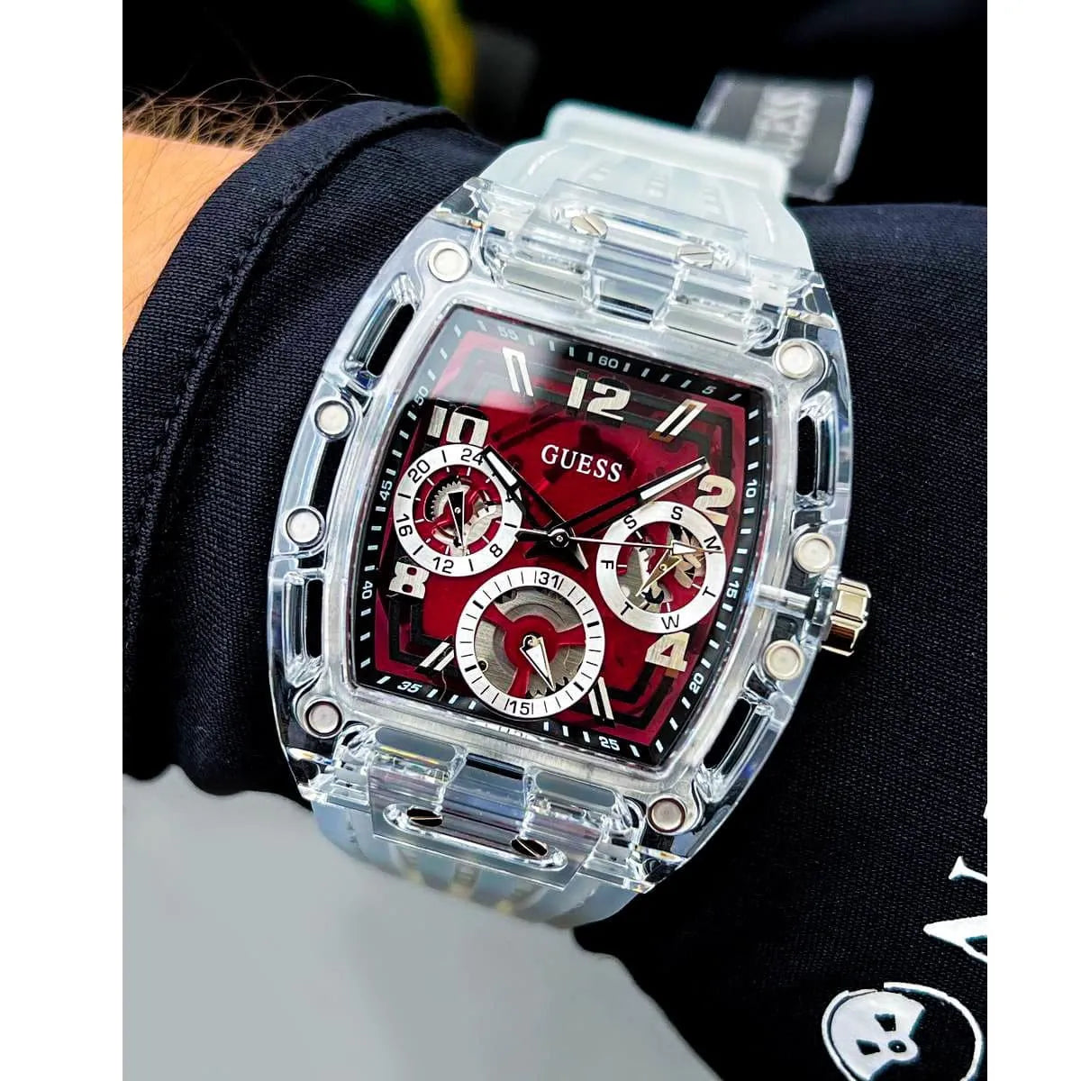 Guess Phoenix men's watch worn on wrist with burgundy dial and sub-dials visible