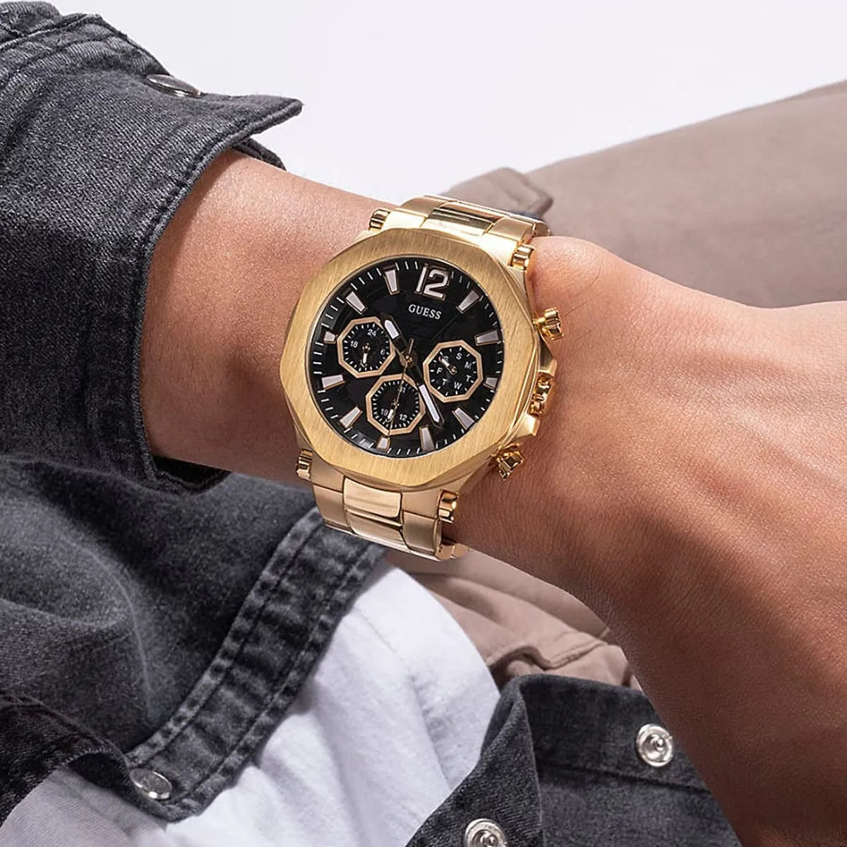 Guess GW0539G2 gold chronograph watch worn on wrist with black dial and subdials visible
