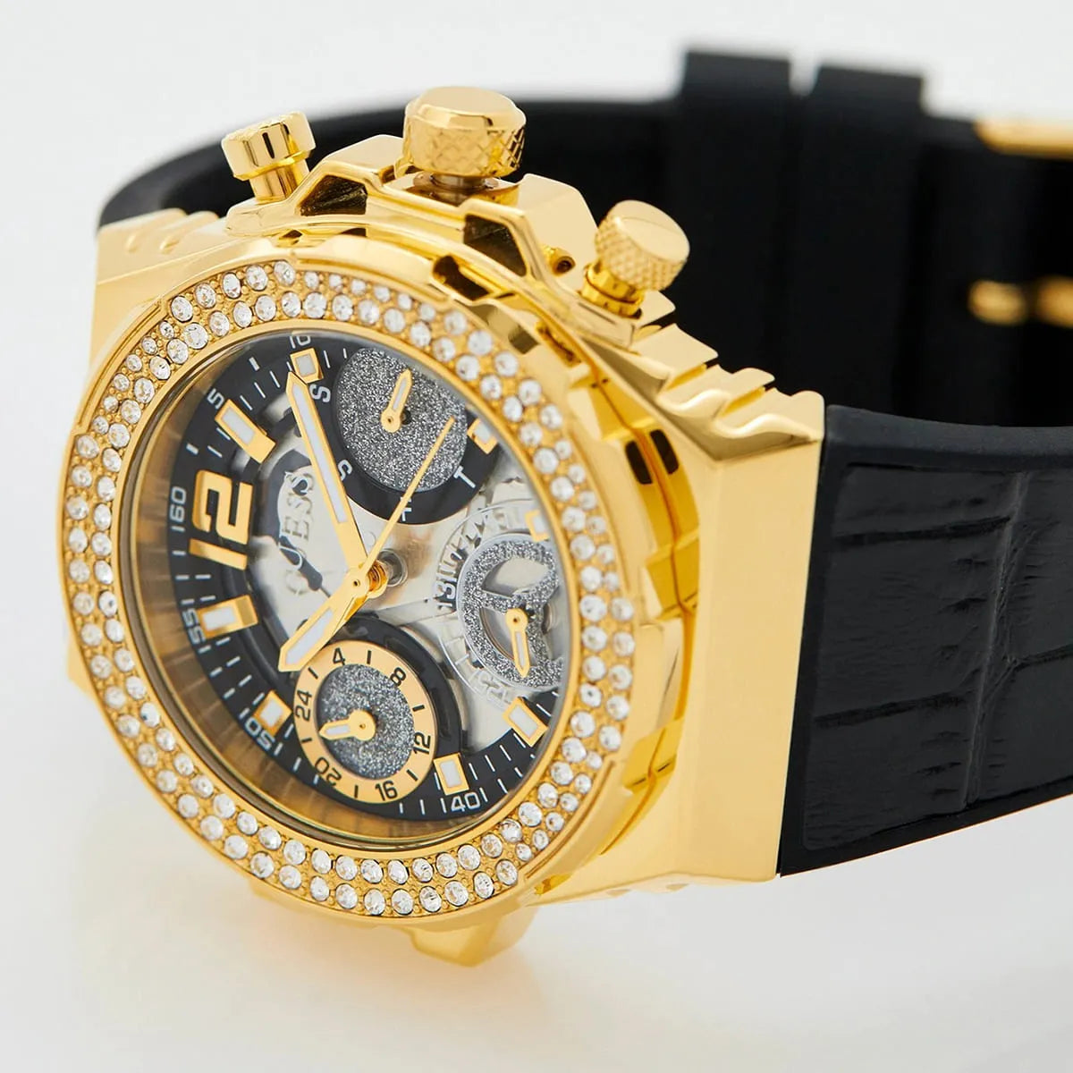 Guess gold watch dial detail showing chronograph subdials and crystal bezel close-up