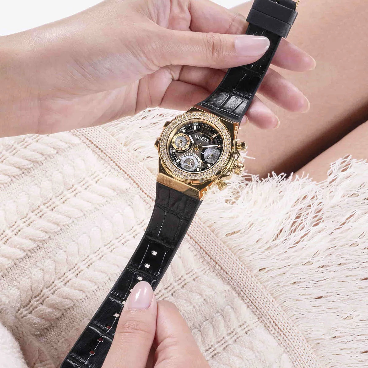 Guess GW0553L4 gold watch worn on woman's wrist, worn on arm detail view