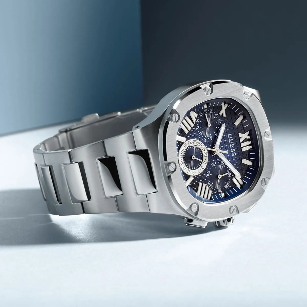 Guess Headliner watch worn on wrist showing blue dial and silver bracelet