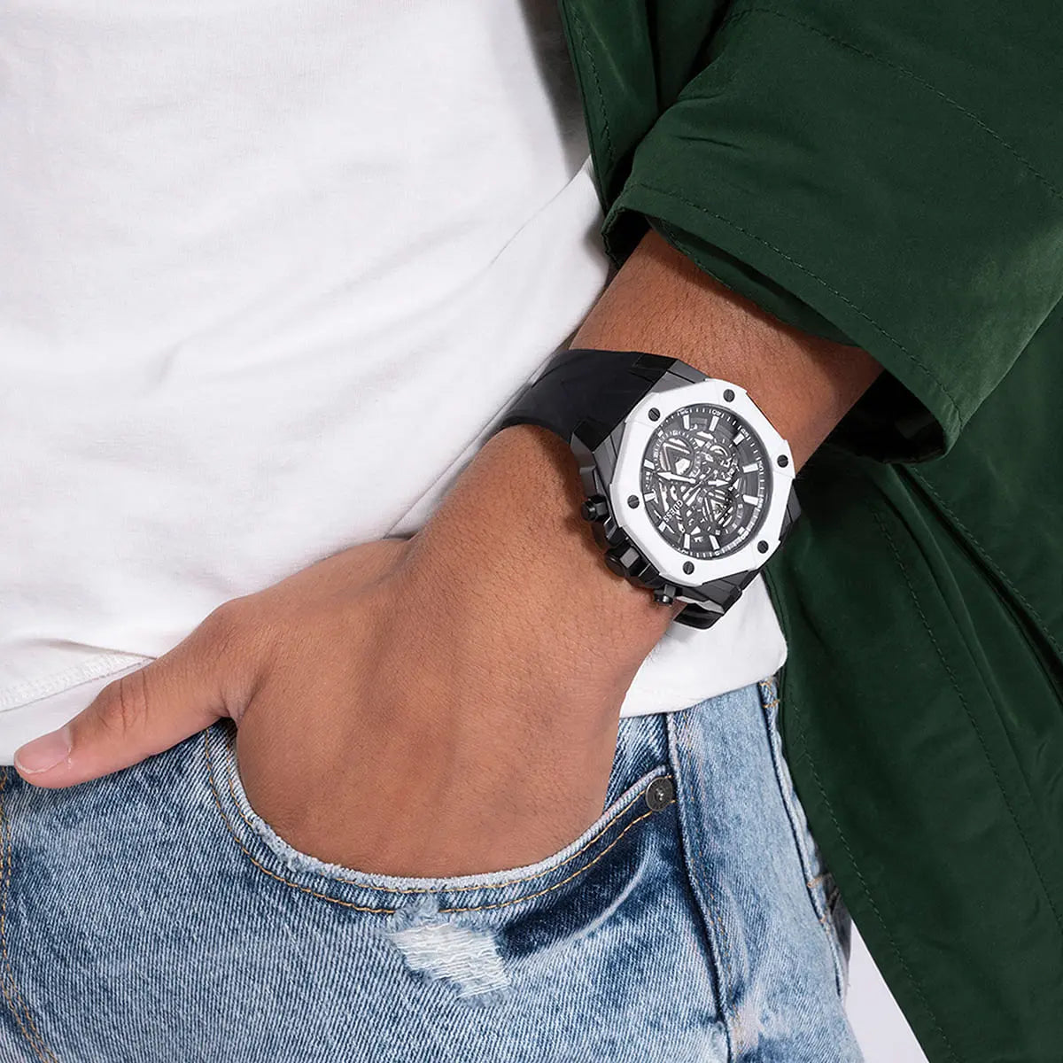 Guess GW0579G1 black skeleton dial watch worn on wrist with white and green sleeves