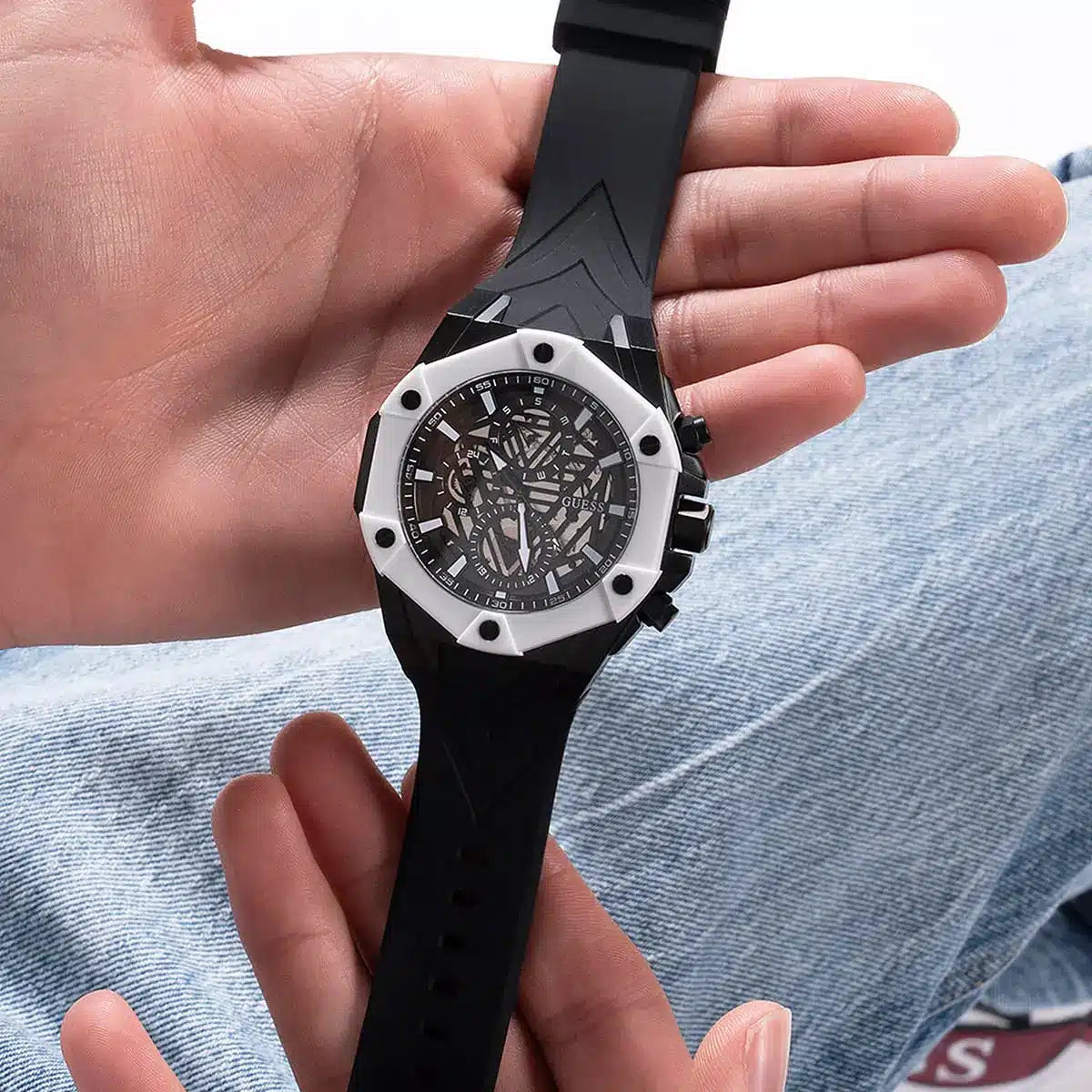 Guess GW0579G1 men's watch on wrist with skeleton black dial and black rubber strap