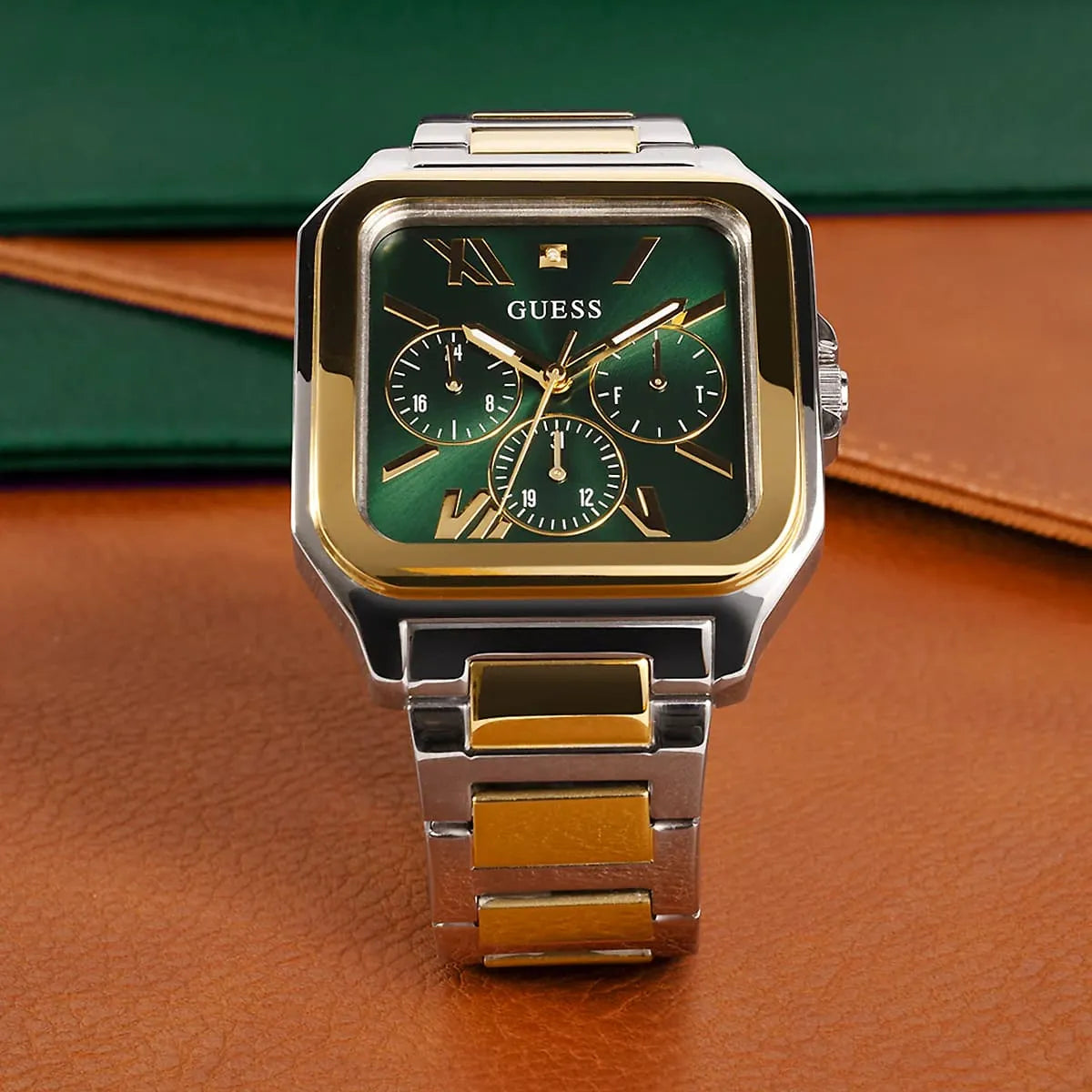 GUESS GW0631G1 multi-tone square watch with green dial on colored background display
