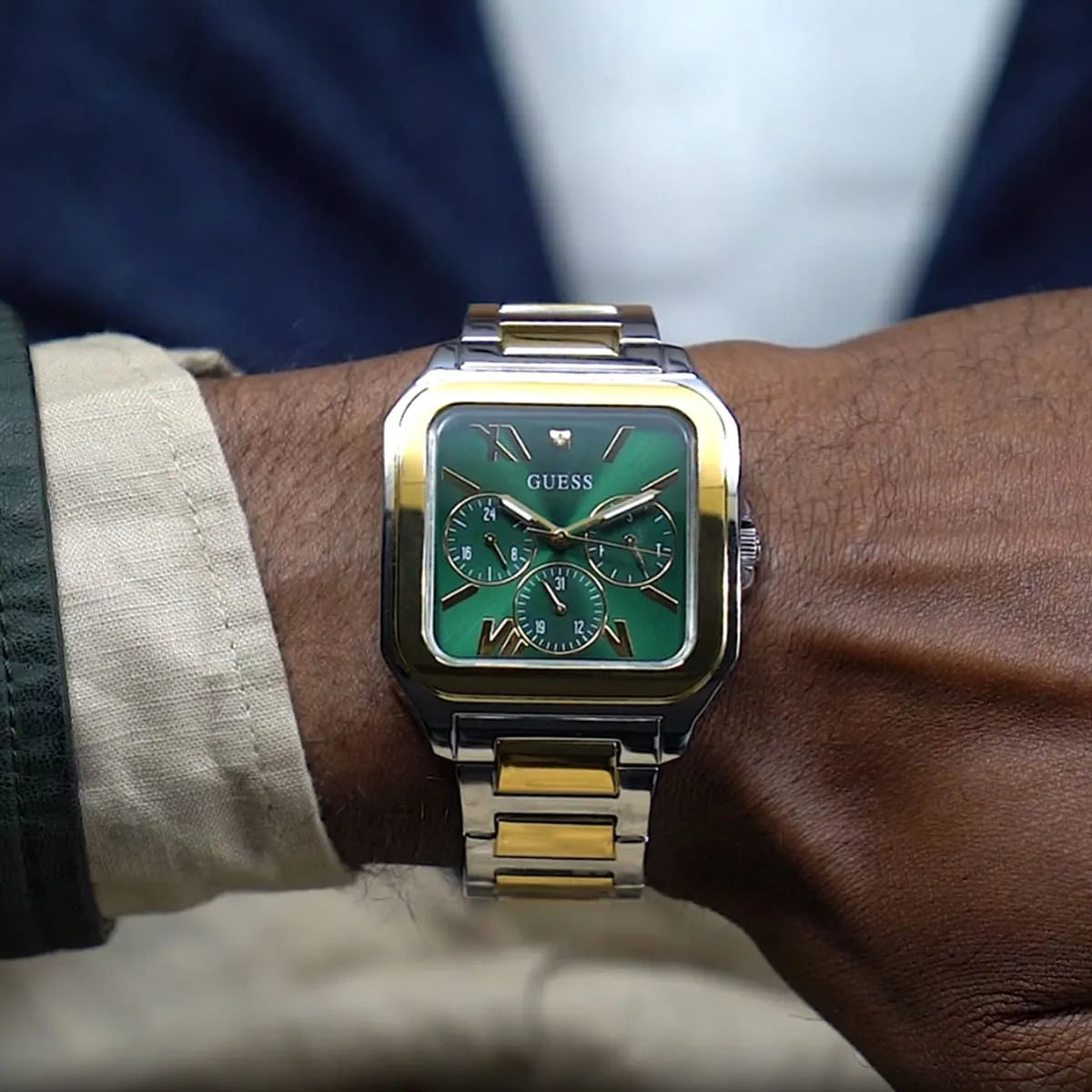 GUESS GW0631G1 square watch worn on wrist showing green dial with chronograph subdials