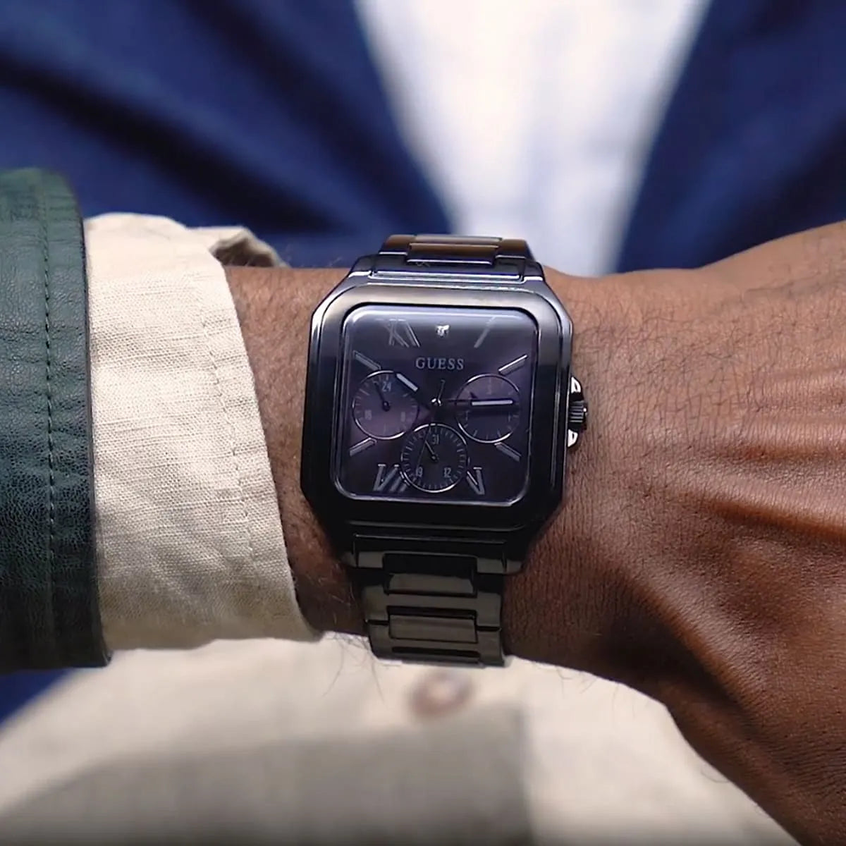 Guess GW0631G2 black watch worn on wrist with dark blue suit and white dress shirt
