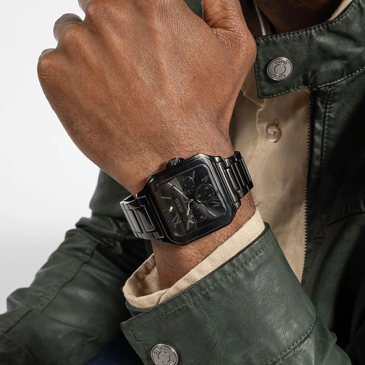 Guess GW0631G2 watch on wrist showing square case and stainless steel band with green jacket
