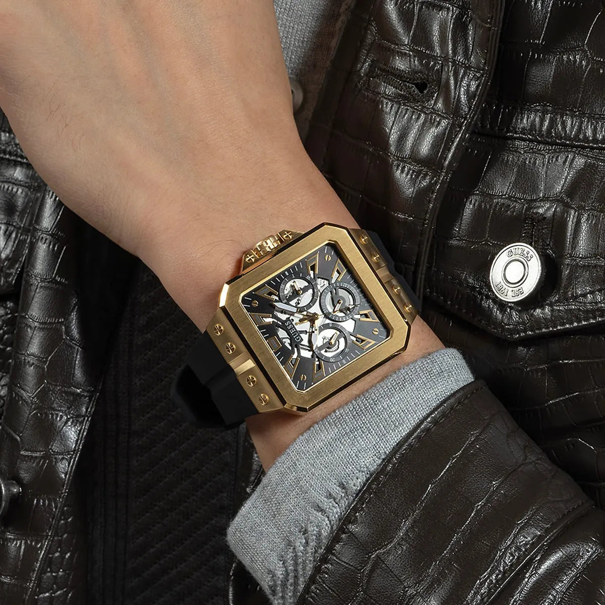 GUESS GW0637G2 gold tone square watch worn on wrist with multi-function chronograph visible