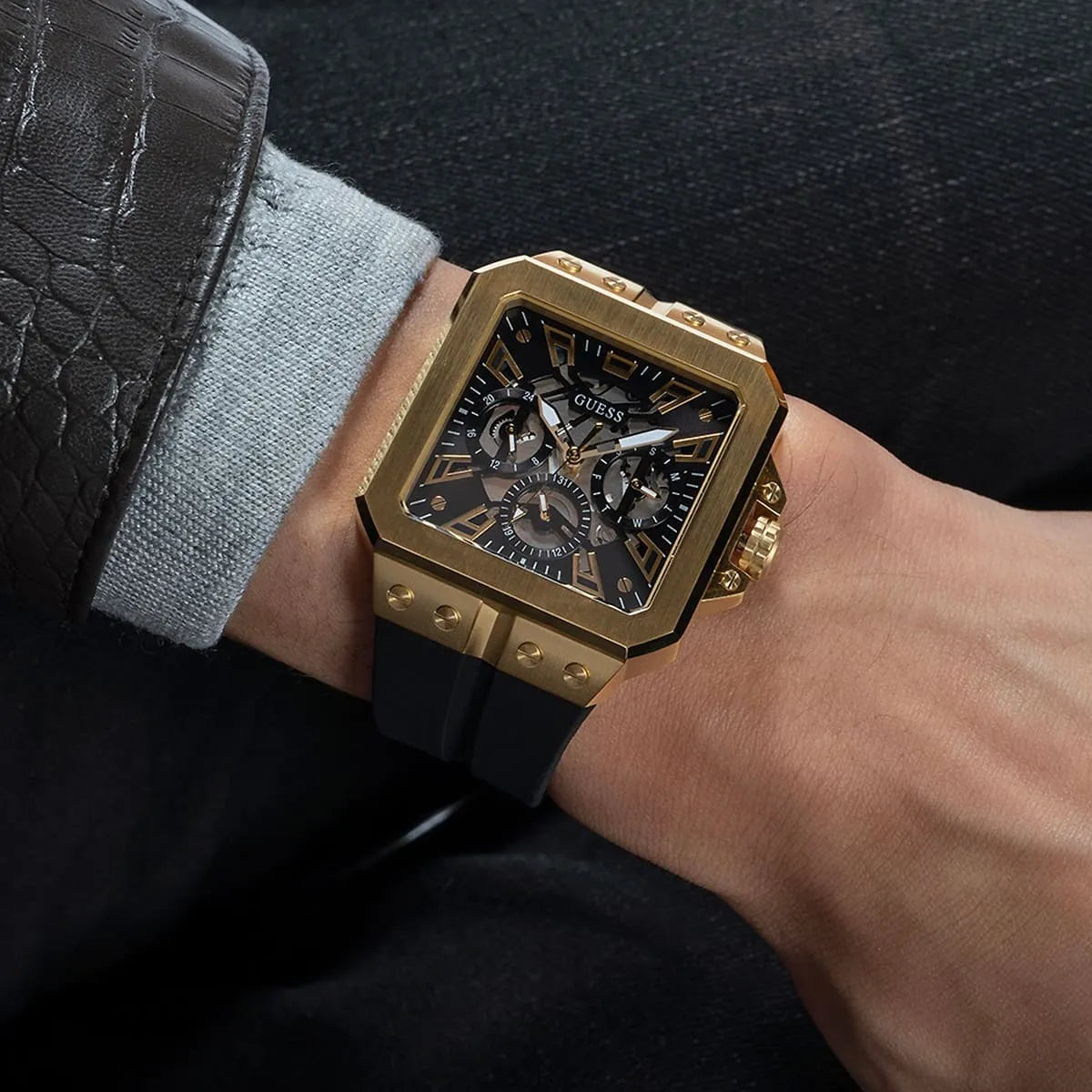 GUESS GW0637G2 worn on wrist showing black dial with multi-function chronograph and gold tone case