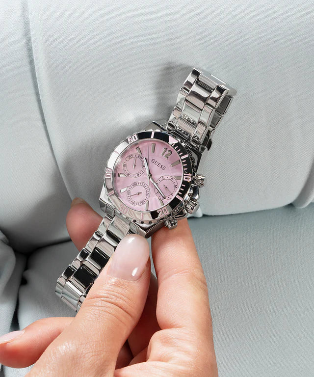 GUESS GW0696L1 multi-function watch worn on wrist showing pink dial and silver bracelet