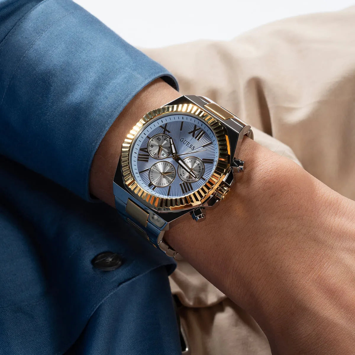 GUESS Equity men's watch on wrist displaying multi-function chronograph face with 2-tone case