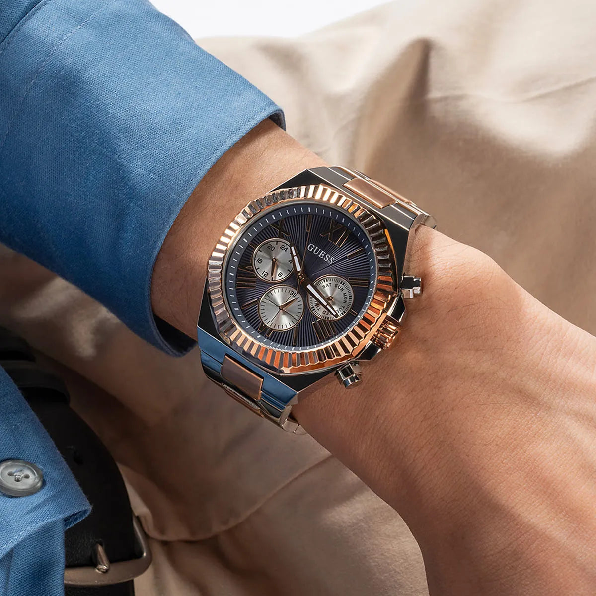 GUESS Equity men's watch worn on wrist showing 2-tone stainless steel bracelet and chronograph subdials
