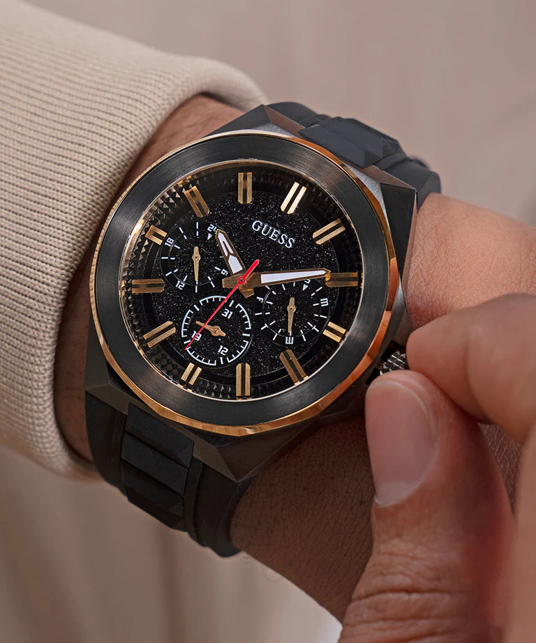 GUESS GW0799G1 worn on wrist showing black and gold-tone chronograph watch