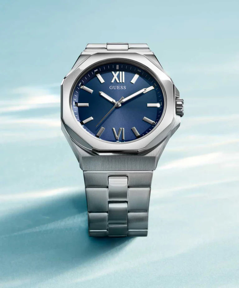 GUESS watch at angle showing octagonal case, blue dial, and stainless steel band