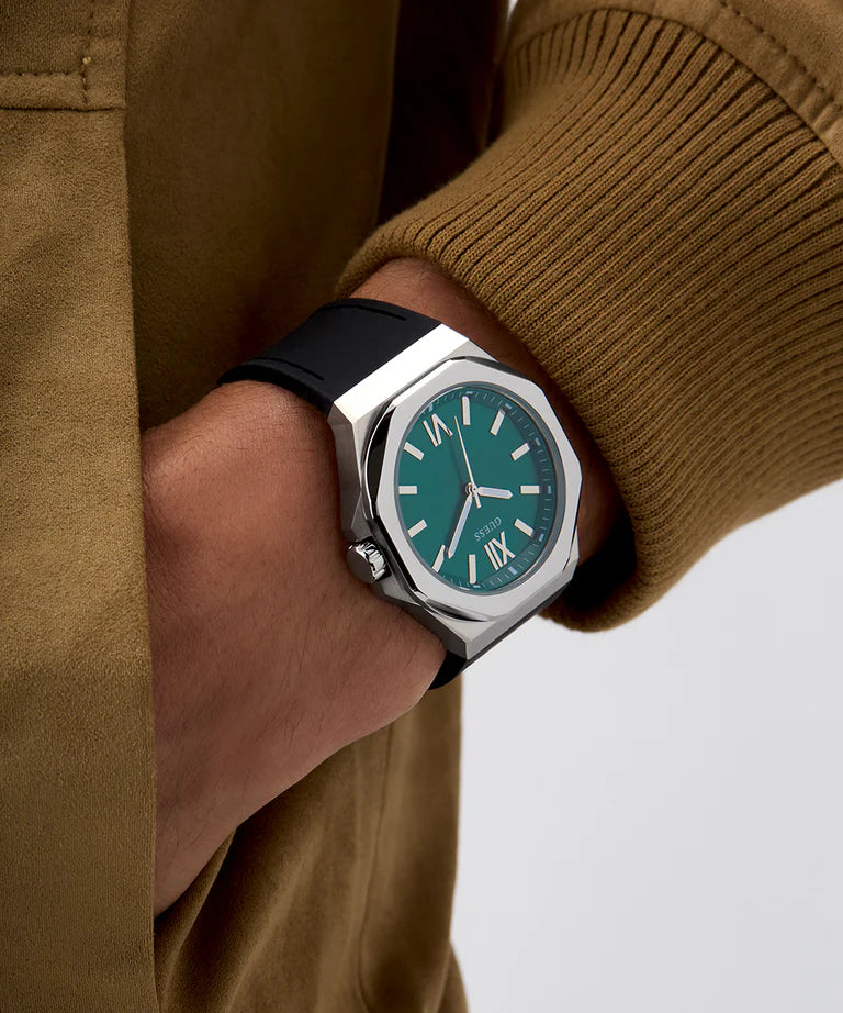 GUESS GW0850G1 analog watch on wrist displaying green dial and silver bezel