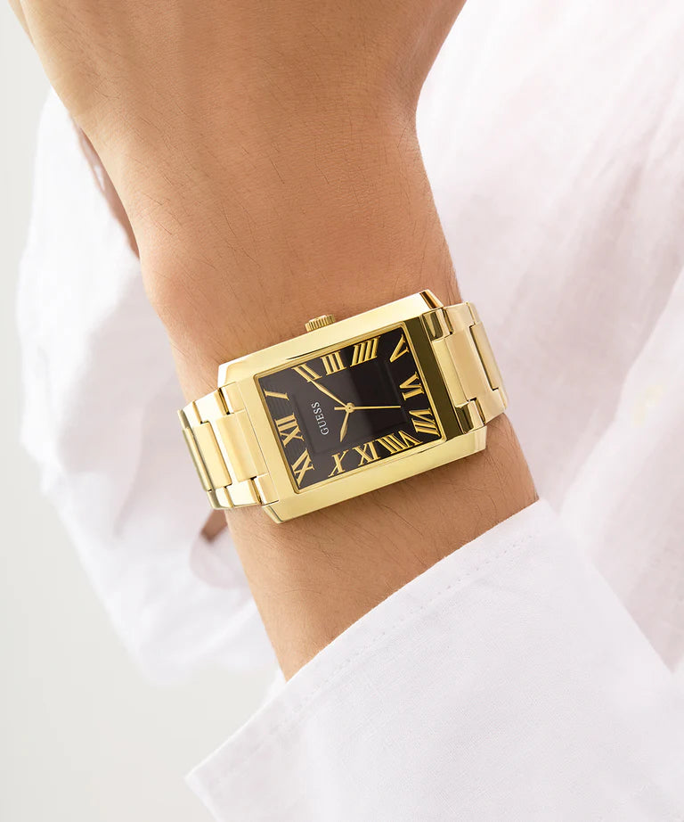Guess Clyde 34mm men's watch worn on wrist with gold-tone case and black dial