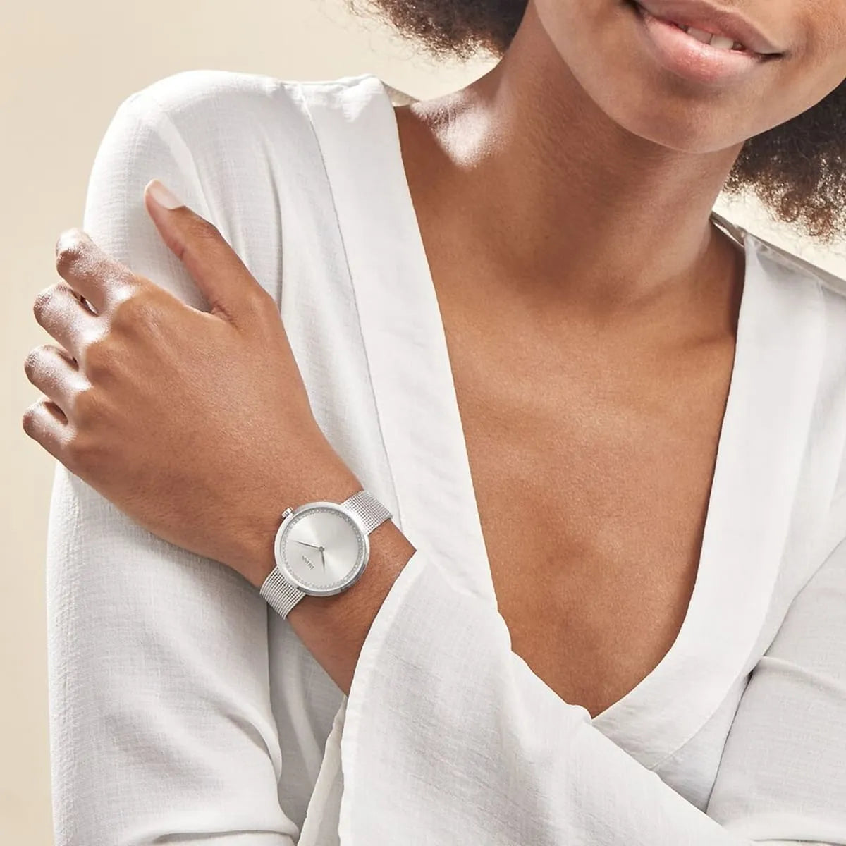 Hugo Boss watch worn on wrist, silver dial with mesh strap, worn with white shirt