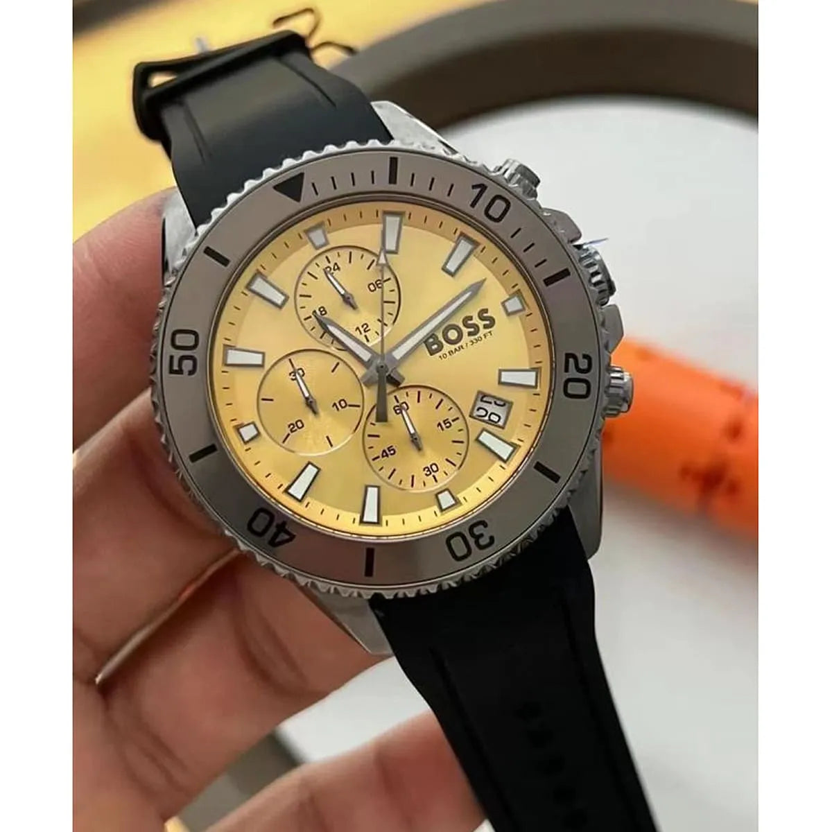 Hugo Boss Admiral chronograph watch held in hand with yellow dial visible